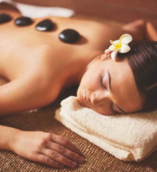 woman-enjoying-stone-massage-min